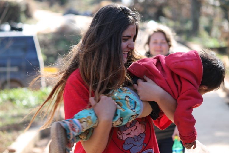ywam-minneapolis-missionary-discipleship-training-school-girl-holding-child-happiness